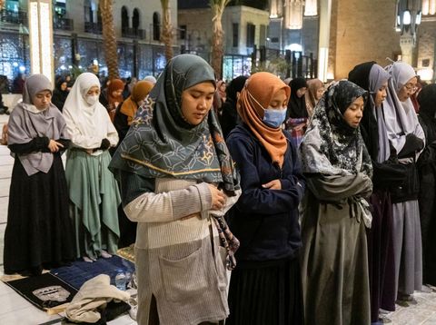 Indonesian student Nuni Nuraini Ahyani, 25, participates in evening prayers called 