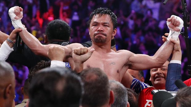 FILE - Manny Pacquiao reacts after defeating Keith Thurman by split decision in a welterweight title fight in Las Vegas, in this Saturday, July 20, 2019, file photo. Pacquiao could have canceled his comeback from a two-year ring layoff when Errol Spence Jr. dropped out less than two weeks before their Aug. 21 fight. Instead, the Filipino congressman gave a career-defining opportunity to Yordenis Ugás, a Cuban veteran who now has the welterweight title belt Pacquiao recently held. (AP Photo/John Locher, File)